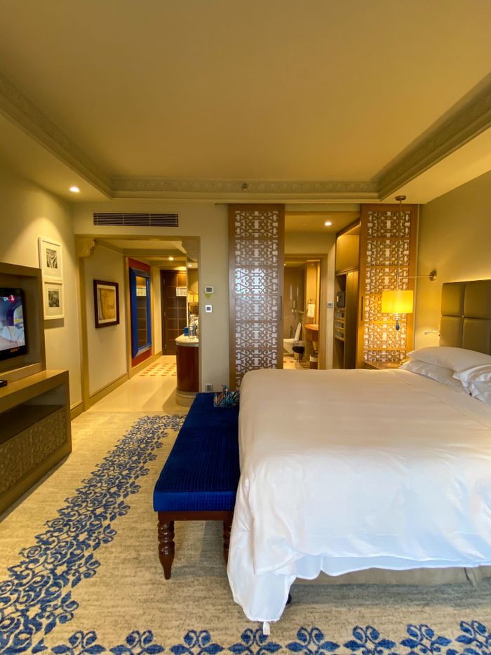 Spacious luxury hotel room with elegant decor and modern amenities located in Mumbai, India.
