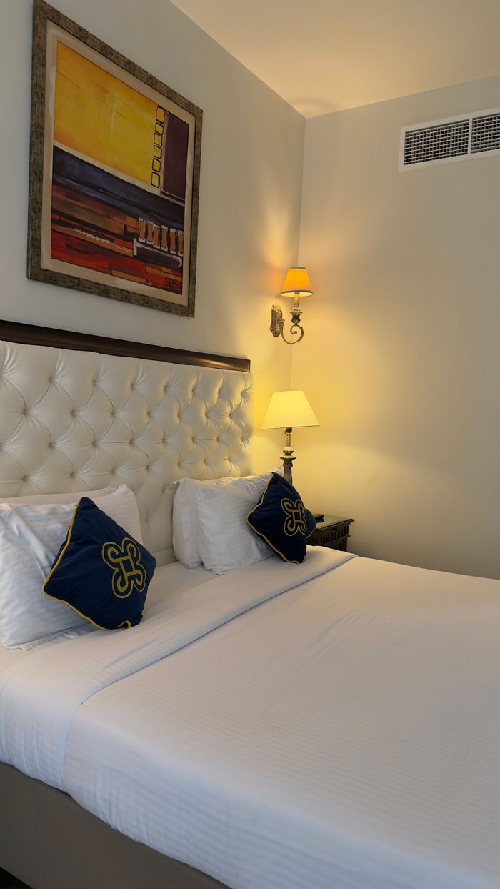 Stylish hotel room showcasing elegant decor with warm ambient lighting and modern art.
